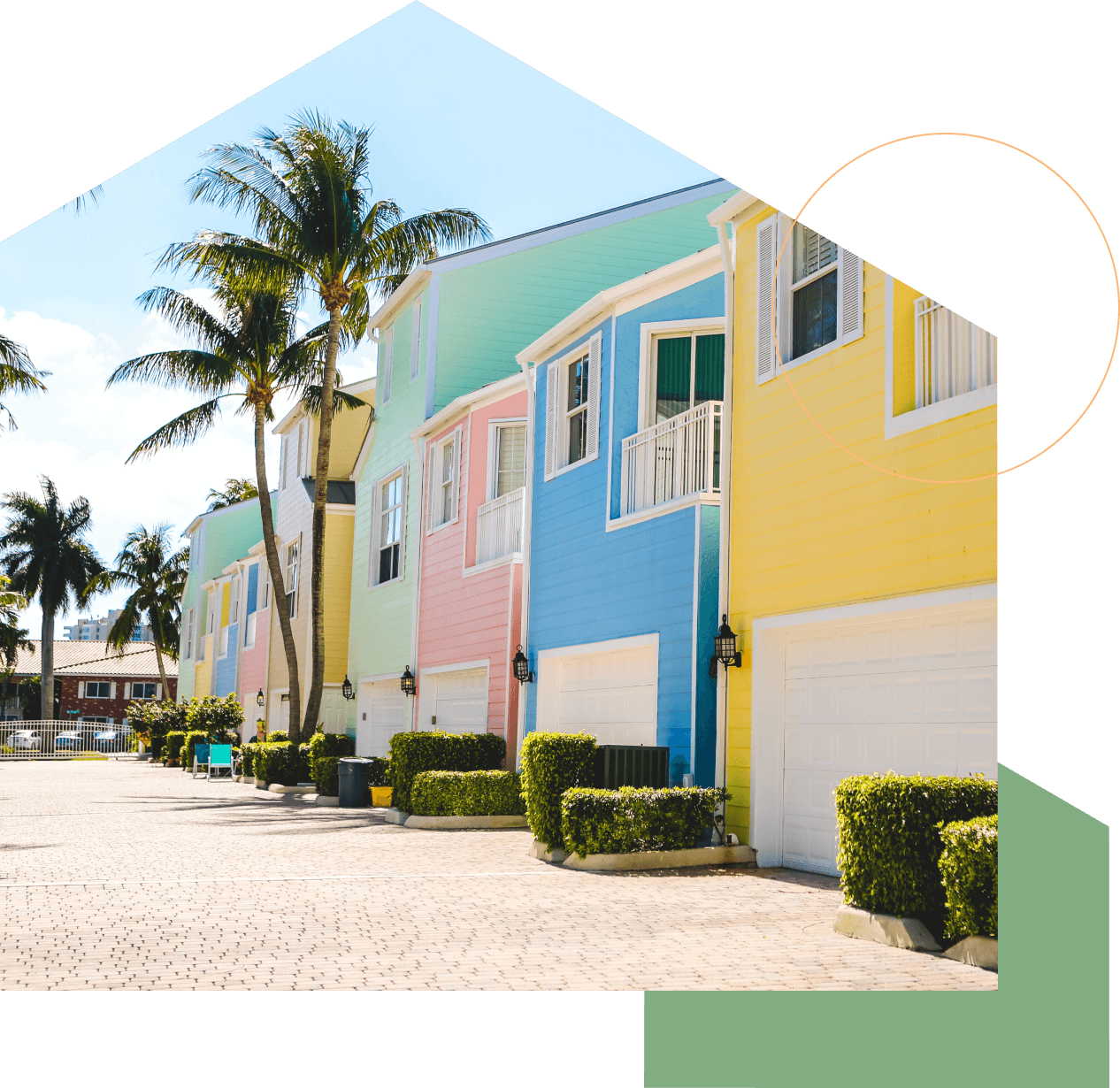 row of brightly colored houses with palm trees in front